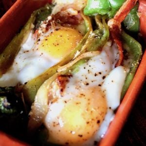 two Roasted stuffed Hatch Chiles with Bacon and Eggs
