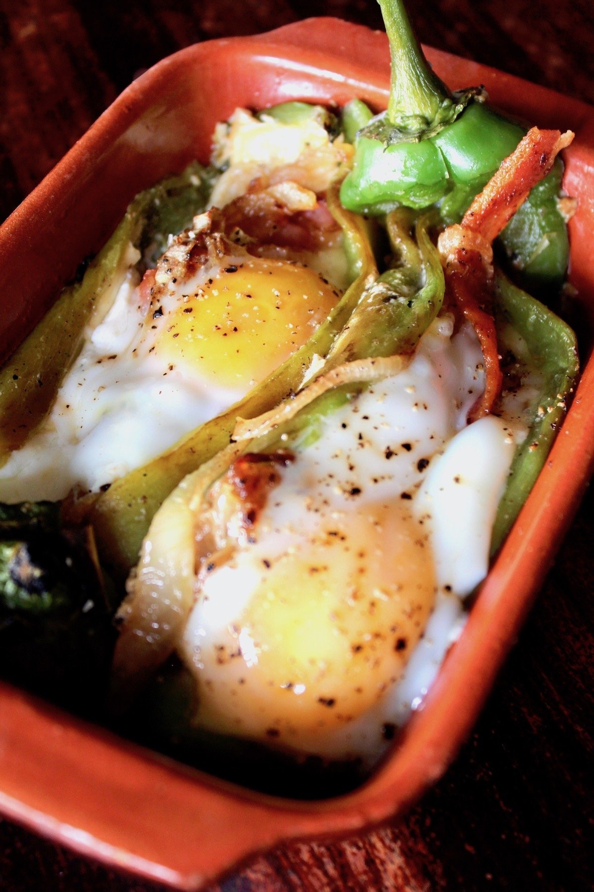 two Roasted stuffed Hatch Chiles with Bacon and Eggs