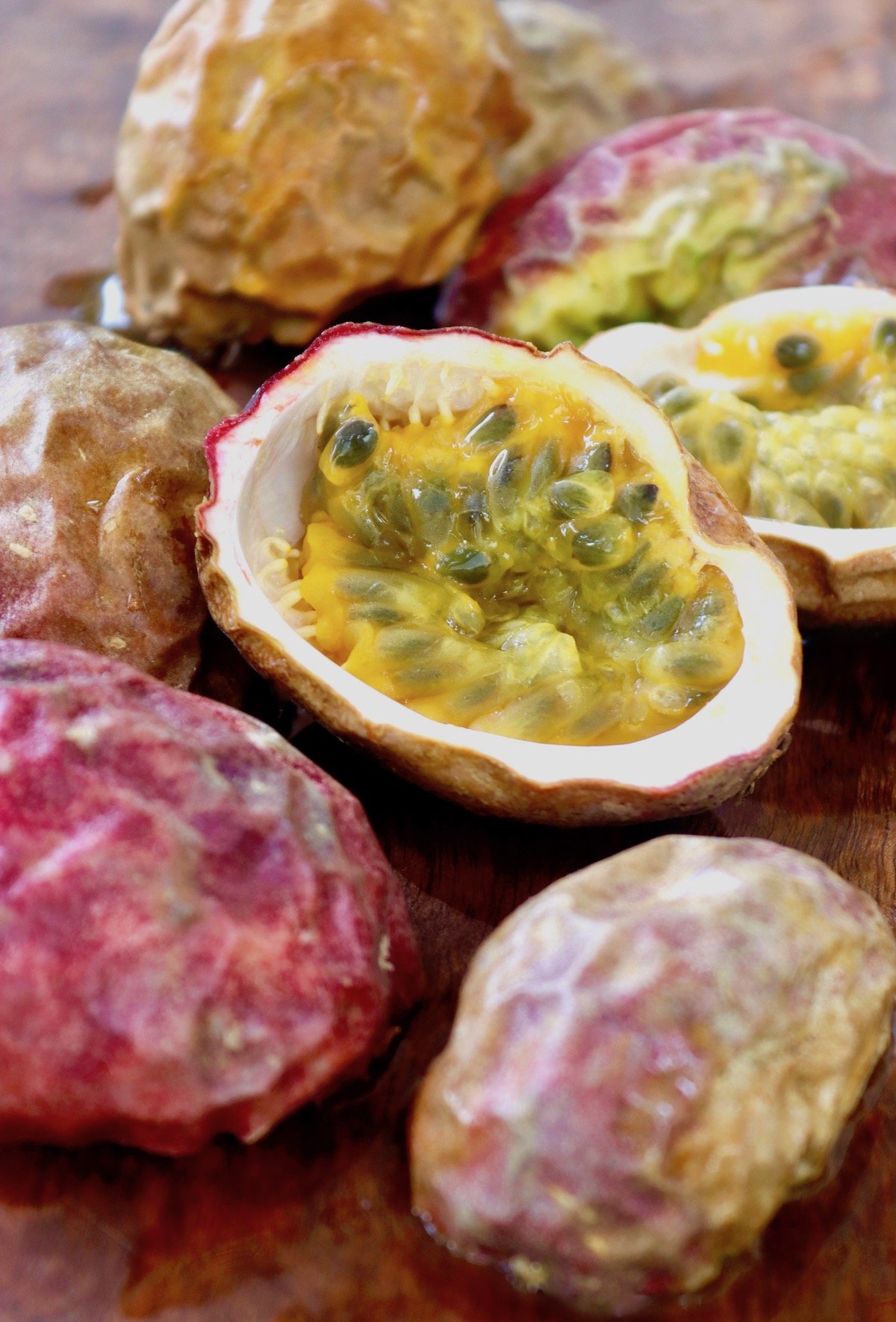 Many passion fruit skins and one facing up with pulp still inside.