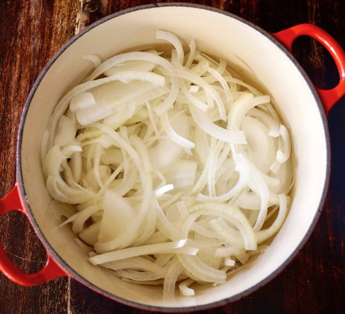 Dutch oven full with onion slices.