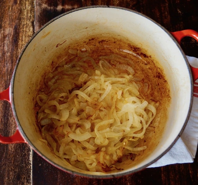 Dutch oven full with golden caramelized onions.