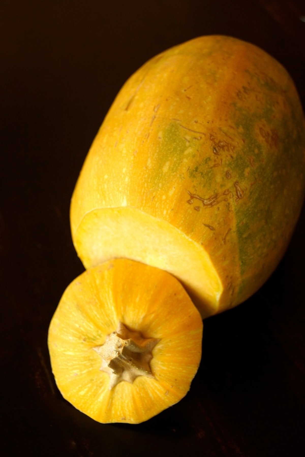 One whole spaghetti squash with the top stem sliced off,