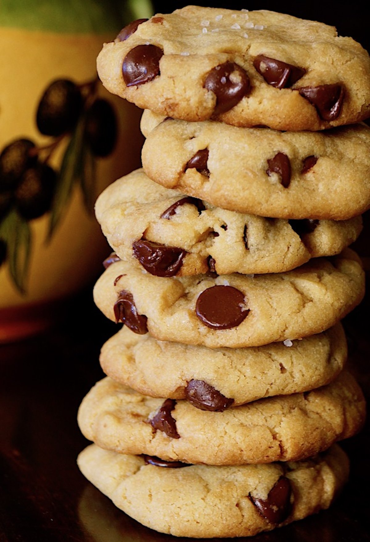 Very tall stack of Olive Oil chocolate chip cookies.