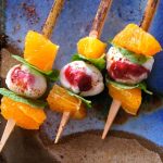 Citrus Caprese Kebabs with tangerines on a blue, creamic plate
