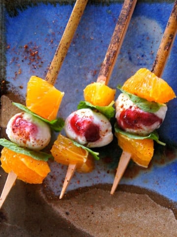 Citrus Caprese Kebabs with tangerines on a blue, creamic plate
