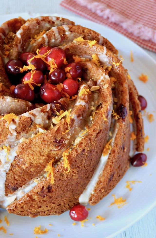 Top view of Cranberry Orange Cake with Amaretto Glaze on white platter