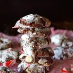 Stack of 5 Peppermint Chocolate Crinkle cookies on pink paper.