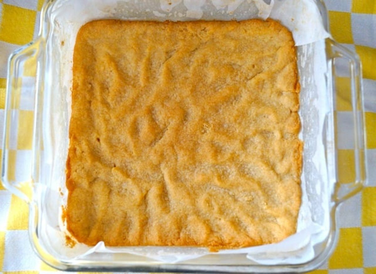 Baked, golden coconut flour crust for lemon bars in an 8 x 8-inch baking pan.