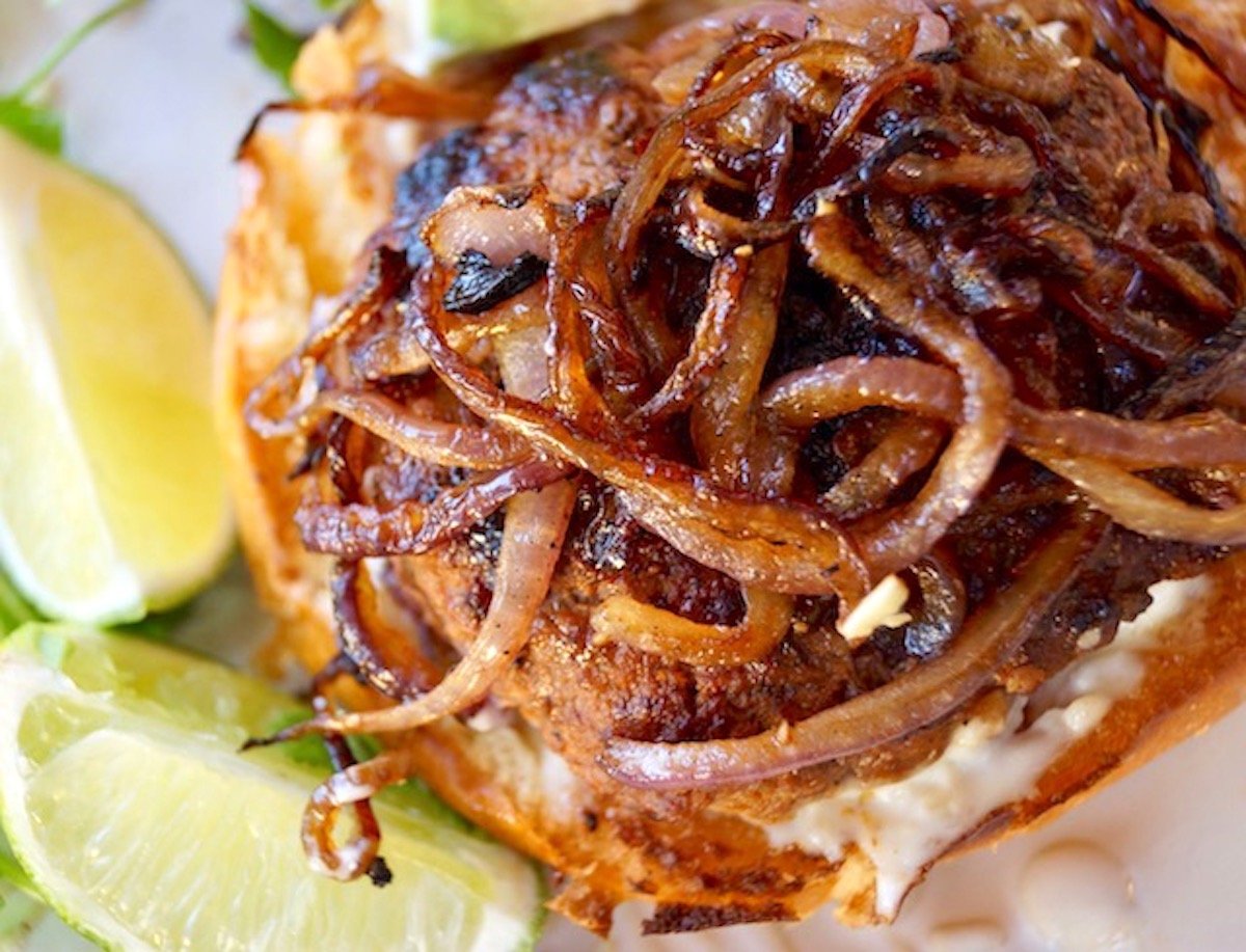 Spicy sriracha burger with caramelized onions on top. 
