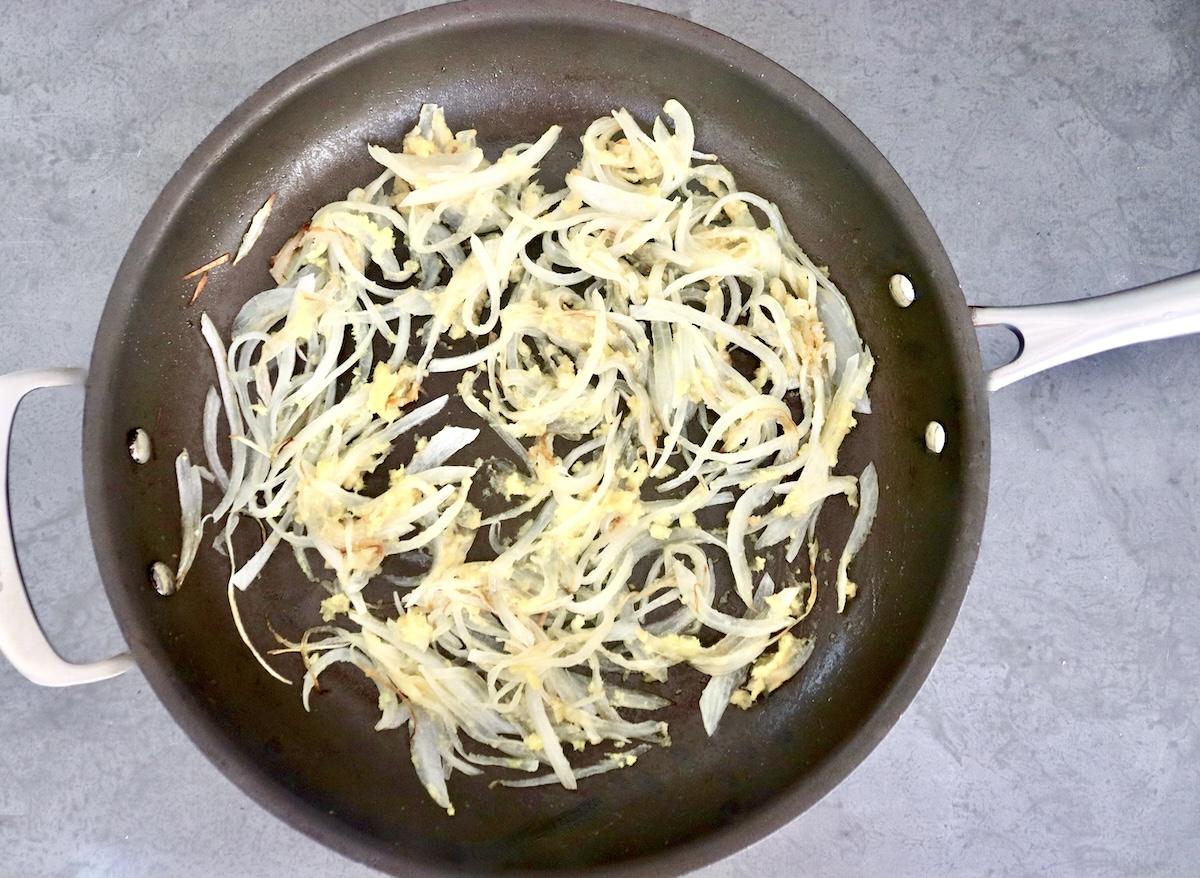 Chinese-Longevity-Noodles-Recipe Large skillet with sautรฉed onion, ginger and garlic.