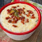 pancetta polenta in red-rimmed bowl