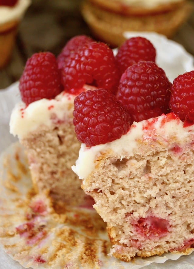 Fresh Raspberry Cupcake cut in half with raspberries on top