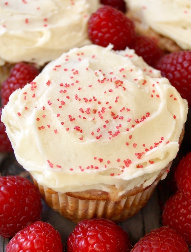 Close up of a butter cream-frosted raspberry cupcake