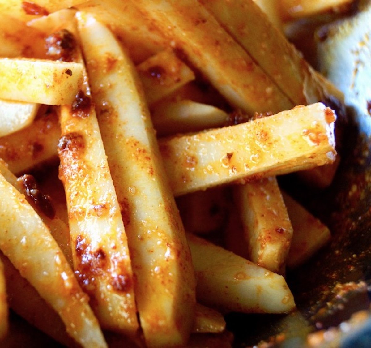 Raw Chipotle Parmesan Fries in a stack.