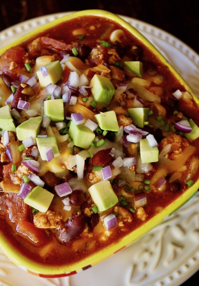Top view of bowl of Vegetarian Tofu Chili with avocado on top