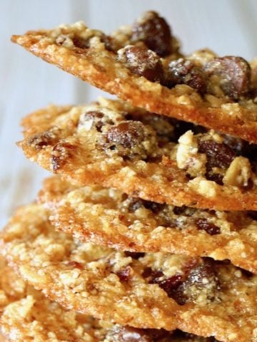 Tall stack of Oatmeal Lace Cookies with white background.