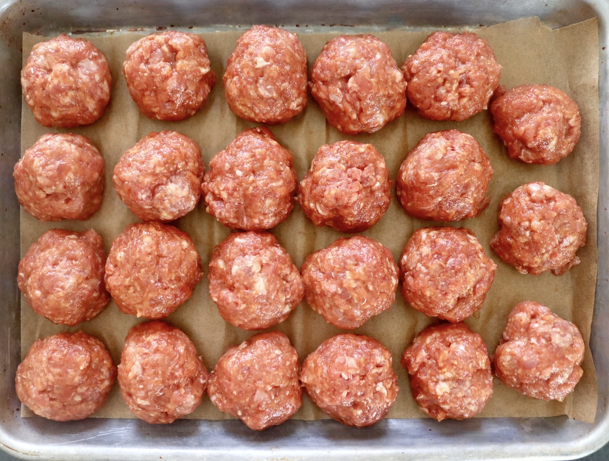 About 1 ½ dozen large meatballs on a parchment-lined sheet pan.