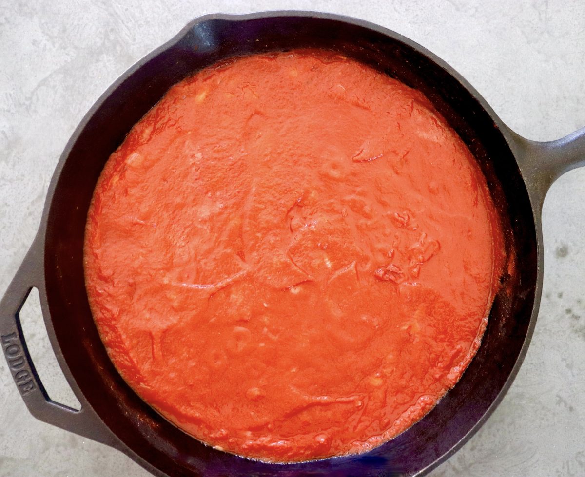 Tomato Sriracha sauce in a cast iron skillet.