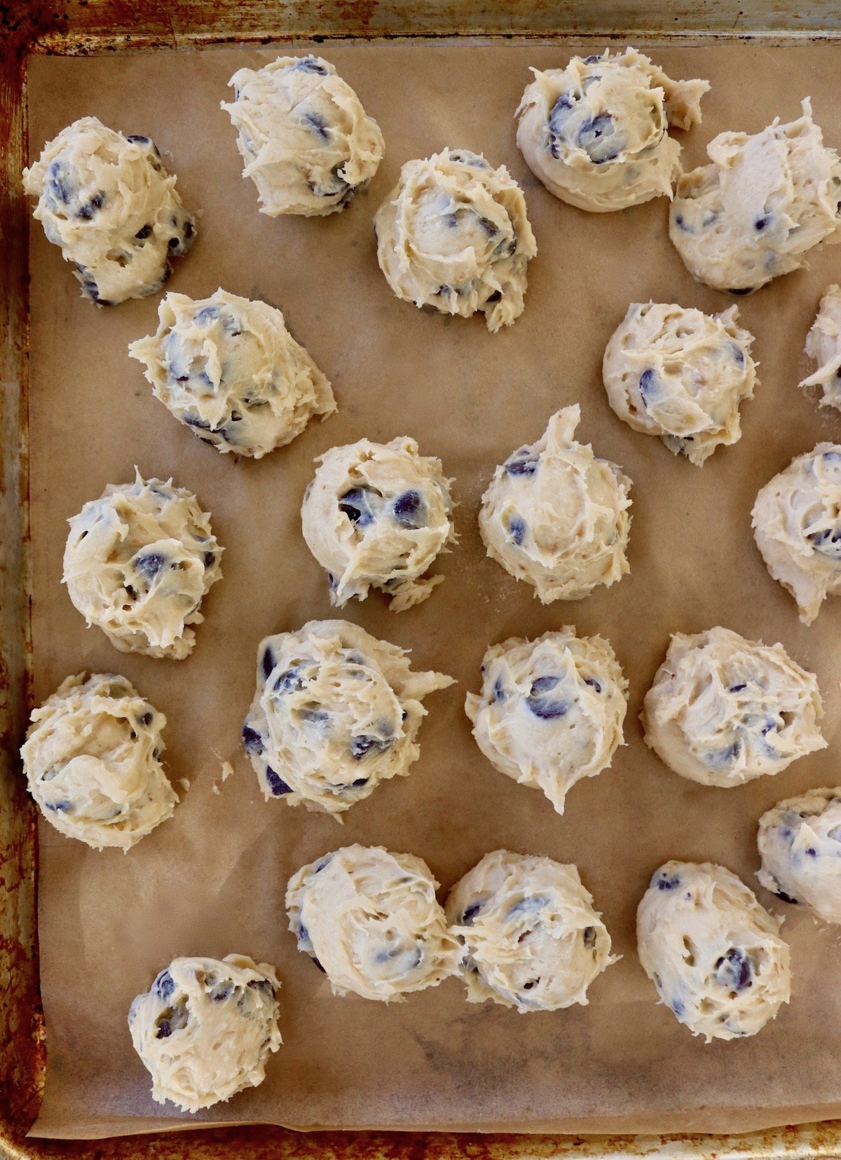 several balls of cookie dough on parchment paper