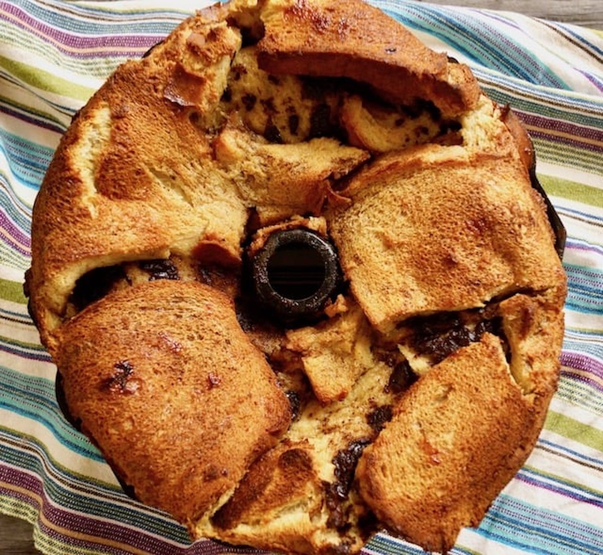 Bundt pan overflowing with French toast bread pudding.