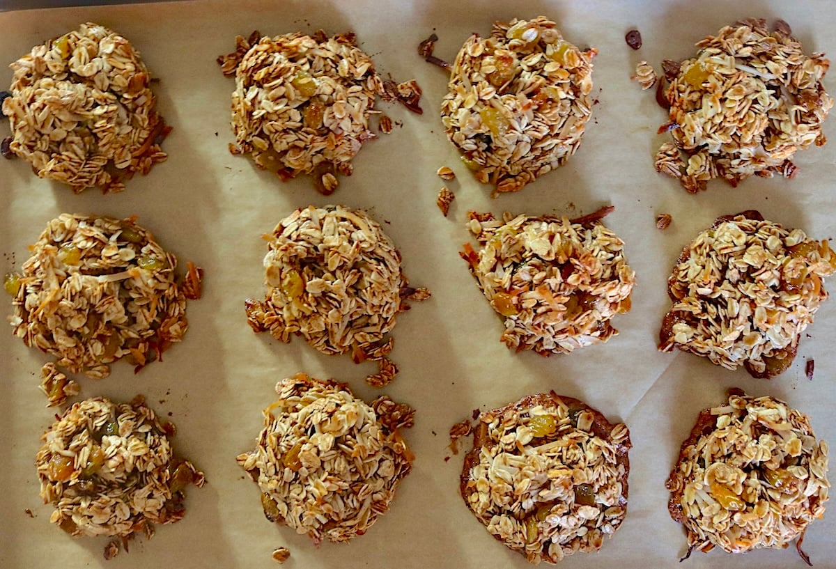 Baked granola cookies on a baking sheet.