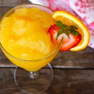 Orange granita in wine glass with strawberry slice