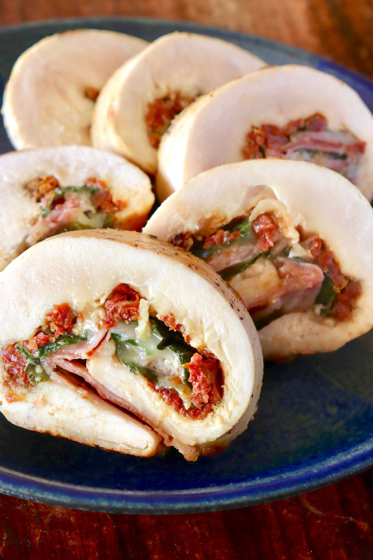 Sliced chicken roulade filled with sun-dried tomato, basil and cheese.