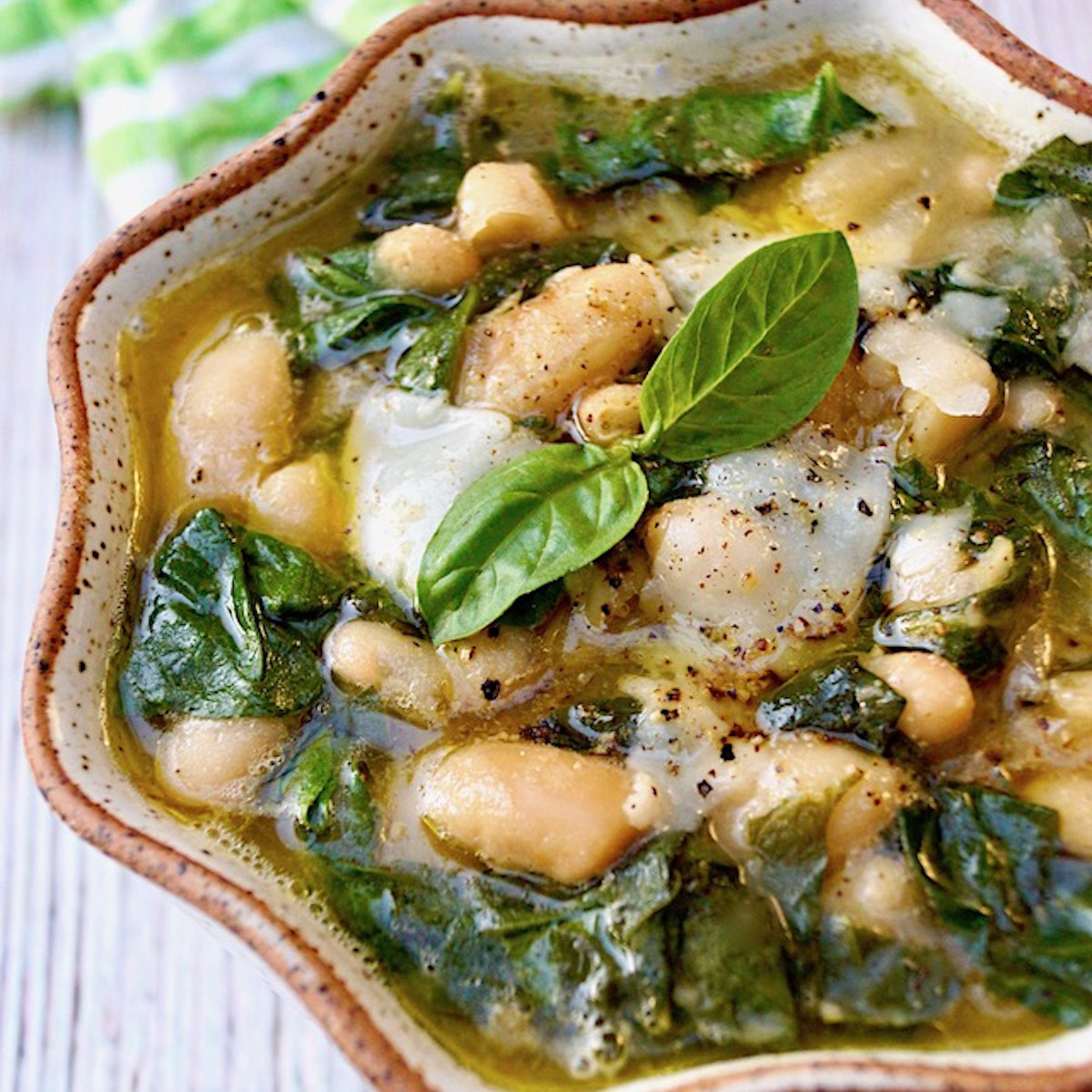 Rich-Slow-Cooked-Flavor—No All-Day-Commitment Vegetarian Tuscan Bean Stew in a ceramic bowl with crimped edges.