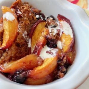 white bowl with peach cobber (gluten-free)