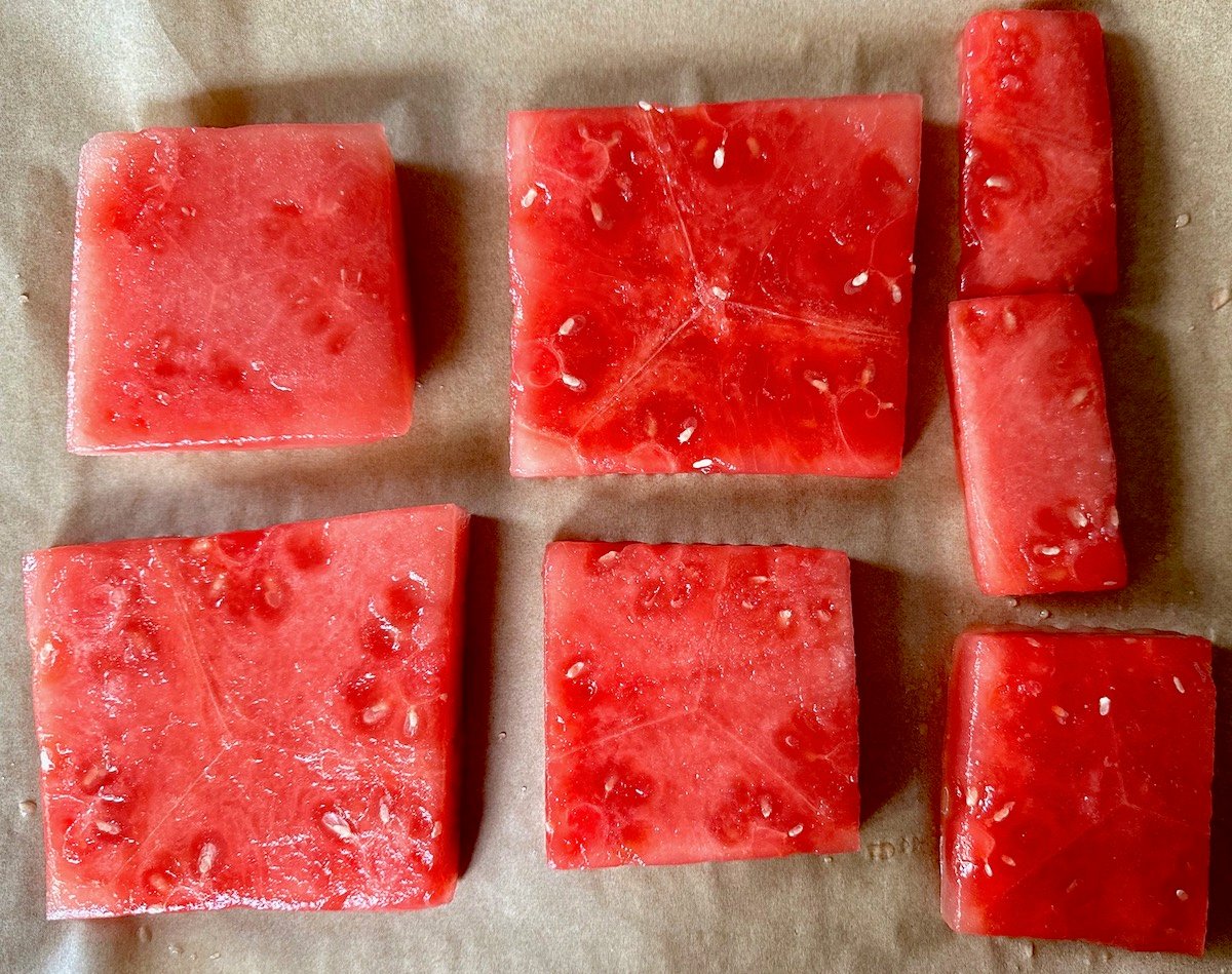 A few slices of watermelon that are a deep red color, that have been compressed.