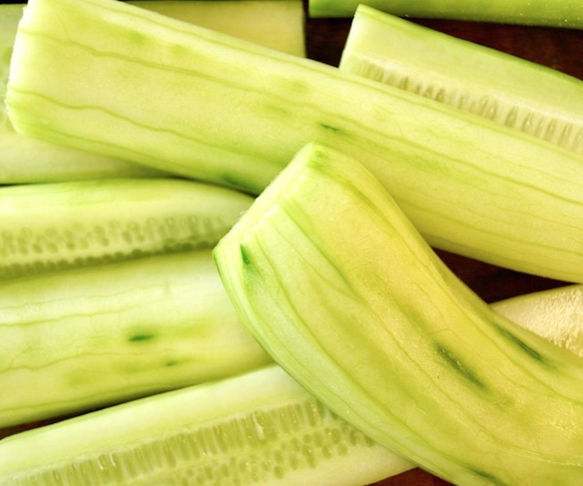 Several peeled English cucumbers cut in half.