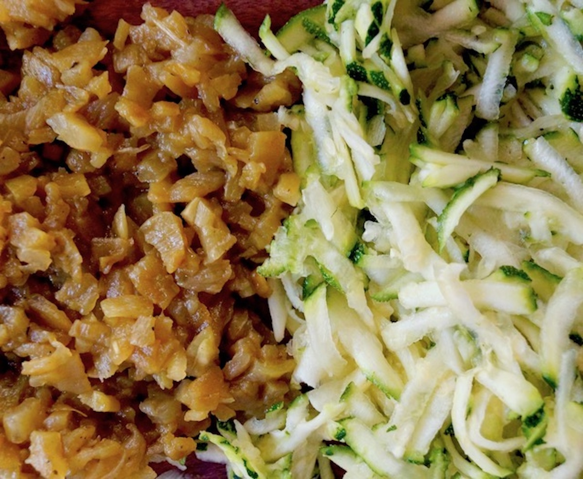 Piles of finely chopped roasted green chiles and grated zucchini.