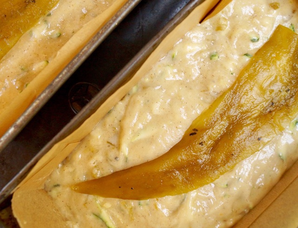 Batter for gluten-free zucchini bread with a hatch chile pepper on top.