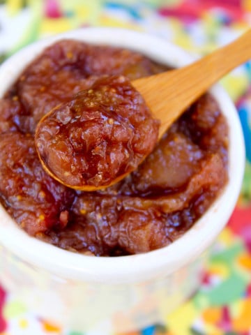 fresh fig preserves in small wooden spoon over small white bowl