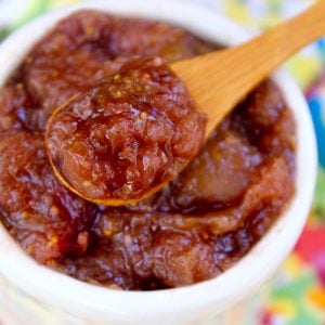 fresh fig preserves in small wooden spoon over small white bowl