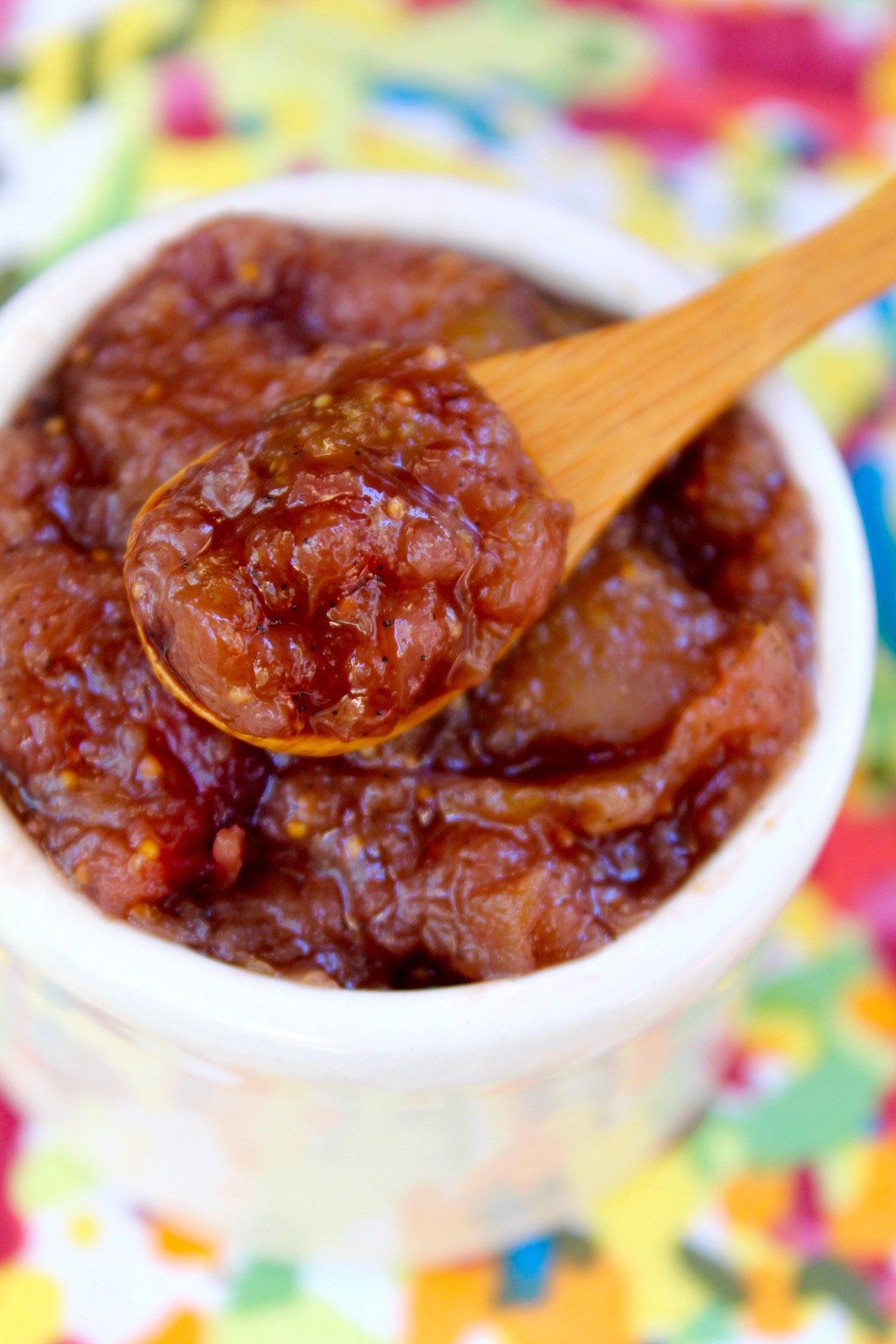 fresh fig preserves in small wooden spoon over small white bowl