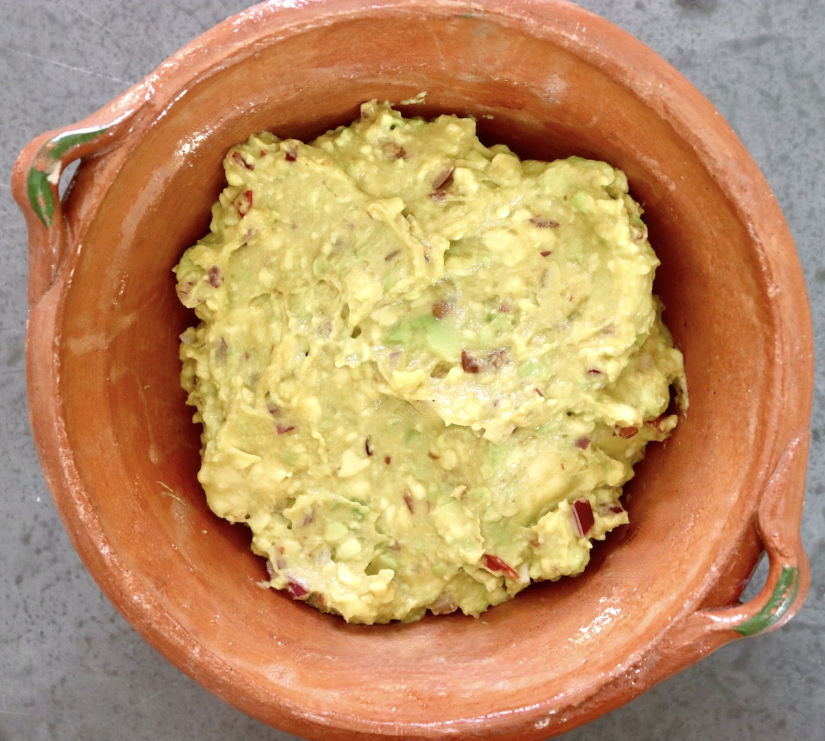 Guacamole in a tsmall erra cotta bowl. 