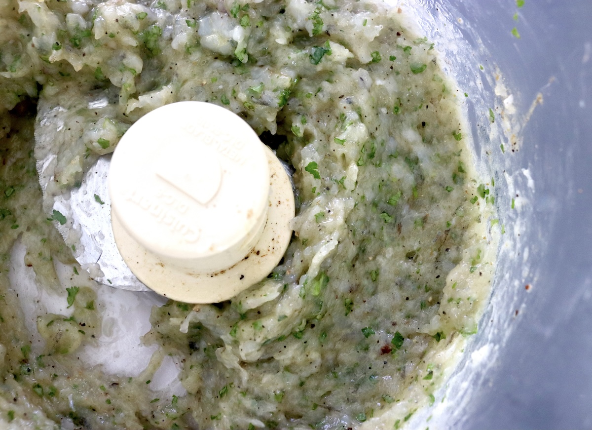 Shrimp paste mixture with cilantro in food processor bowl. 