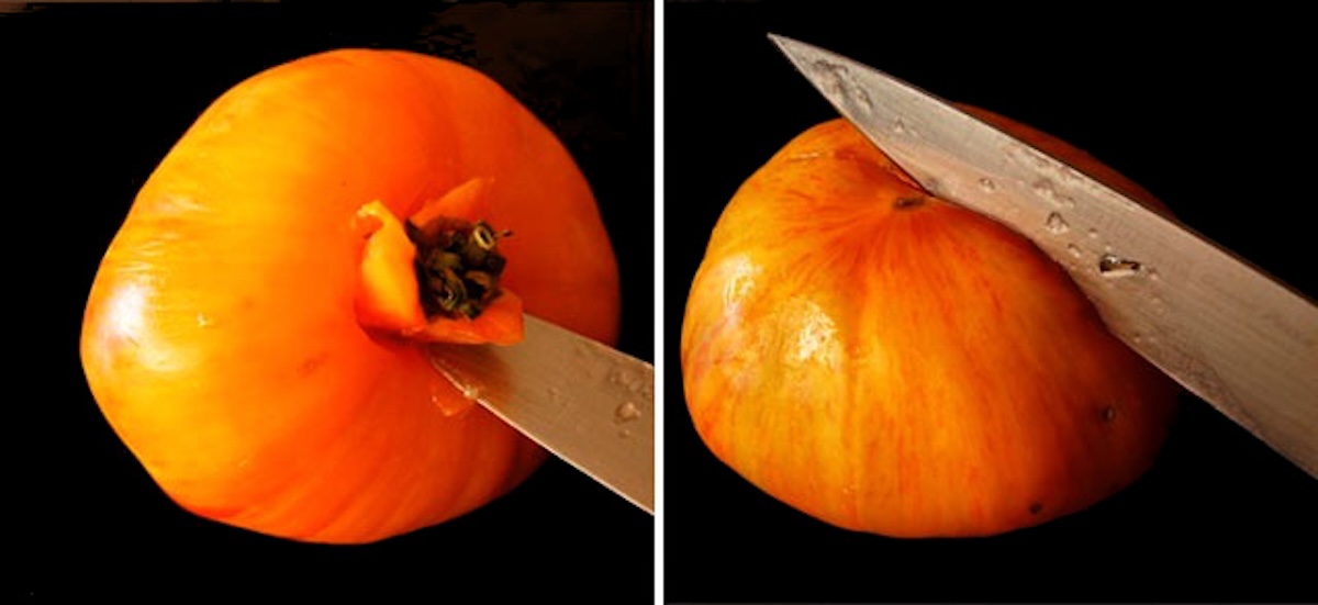 Two tomatoes, one being cored, and one being sliced.