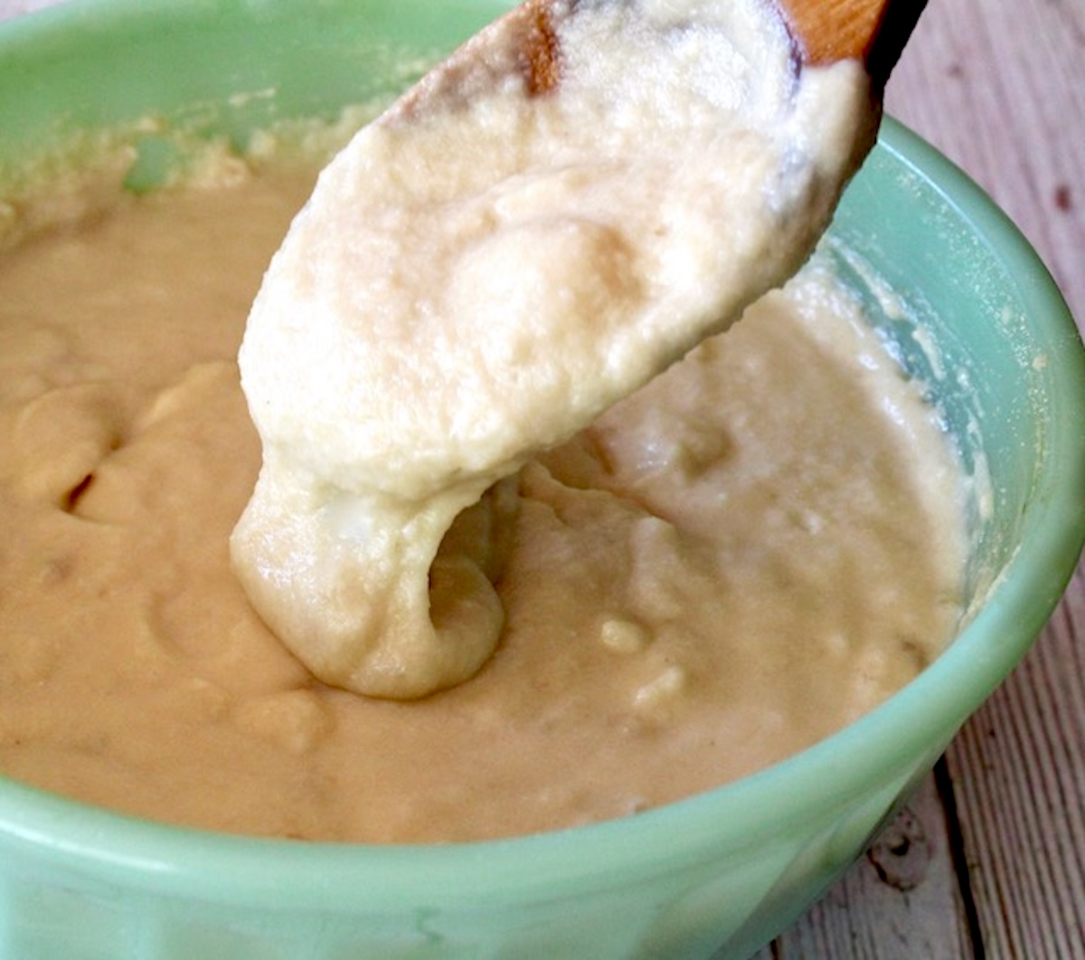 Pancake batter in a light green bowl.