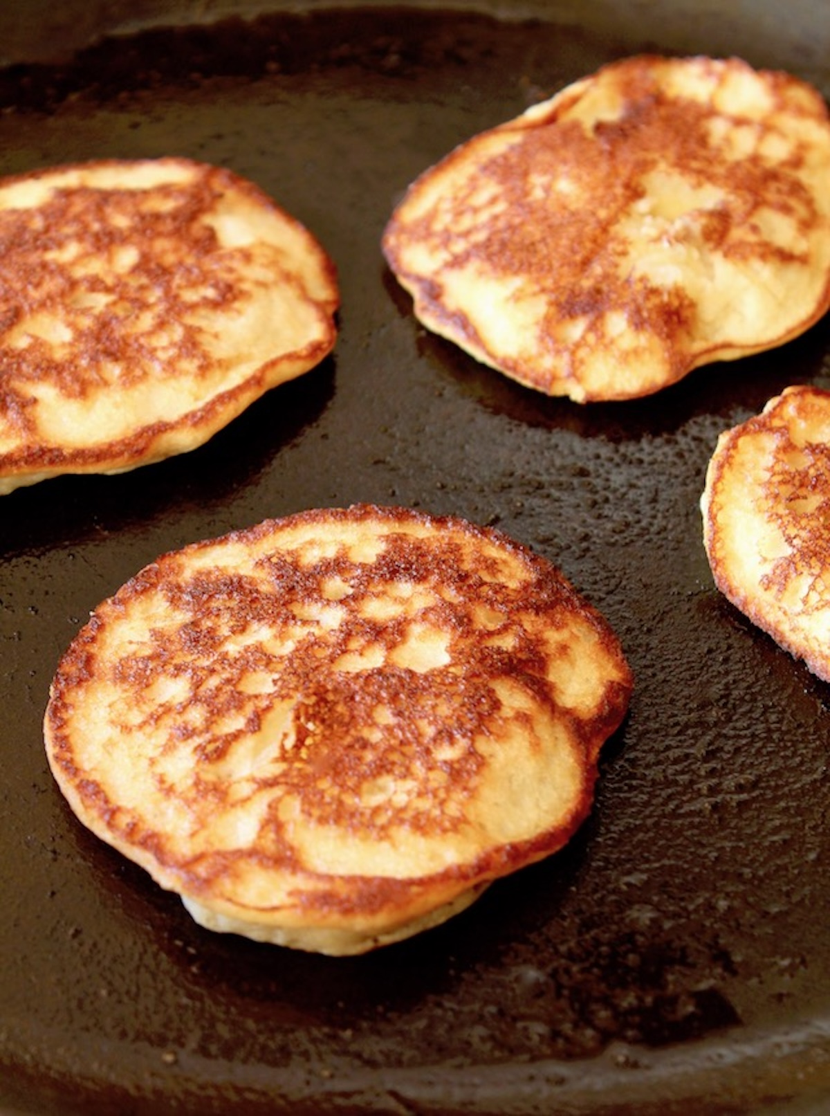 Cooked golden pancakes in saute pan.