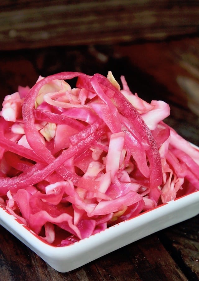 pink pickled cabbage in white dish