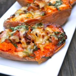 basil baked sweet potatoes with bacon on white plate