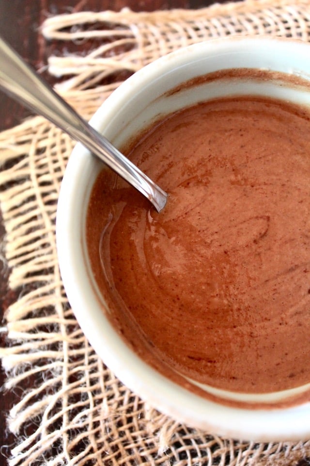 chocolate mousse in white bowl with spoon