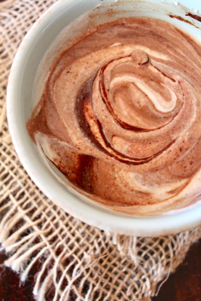 chocolate and cashew cream partially mixed together in white bowl