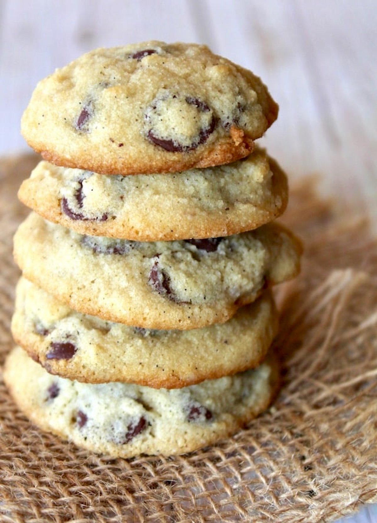 Stack of 5 coconut flour chocolate chip cookies on burlap.