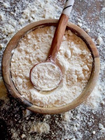 coconut flour in a wooden bowl with wooden spoon