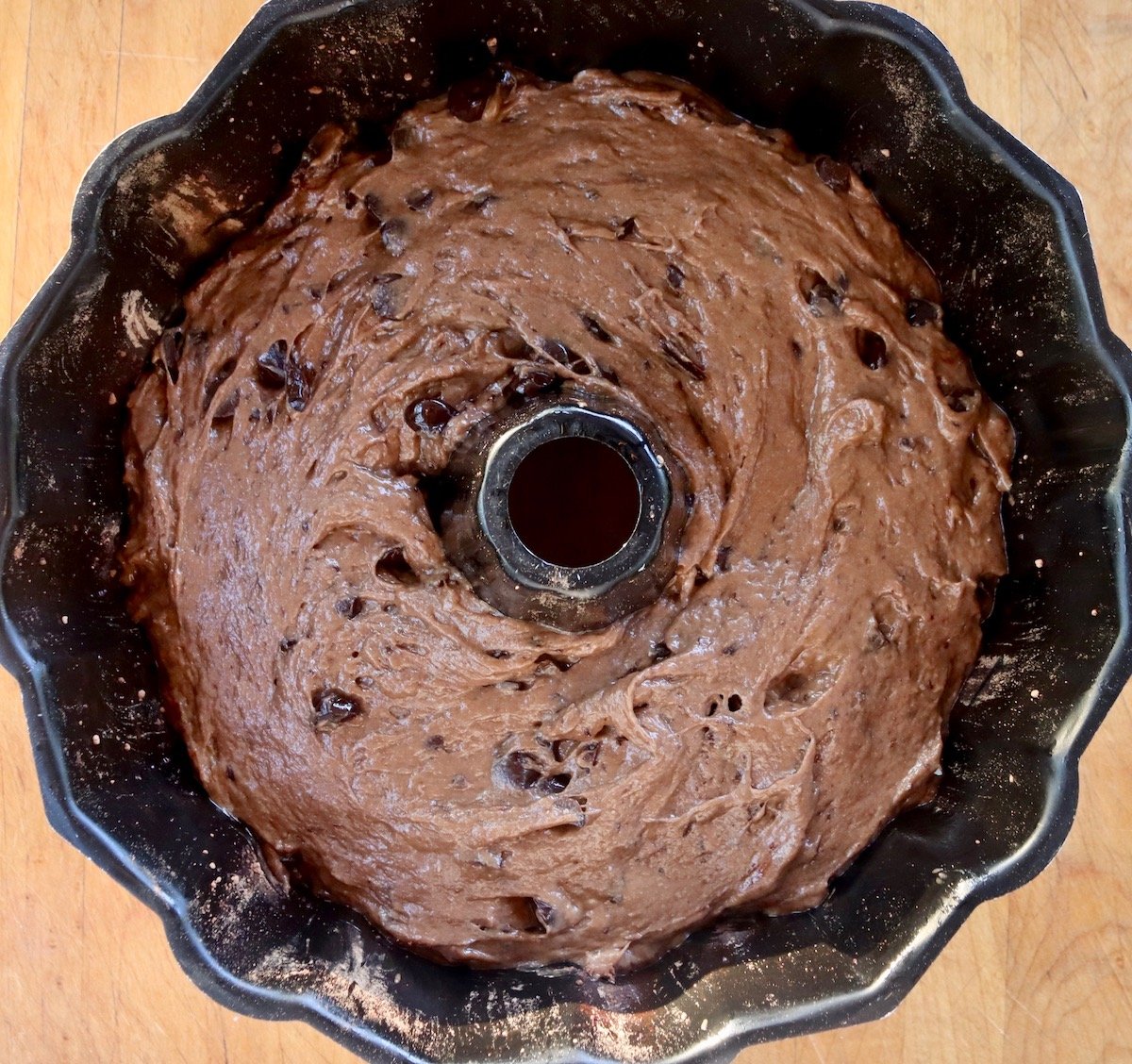 Bundt pan filled with chocolate chip cake batter.