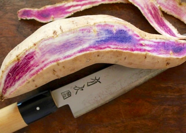 partially peeled okinawan potato with japanese knife