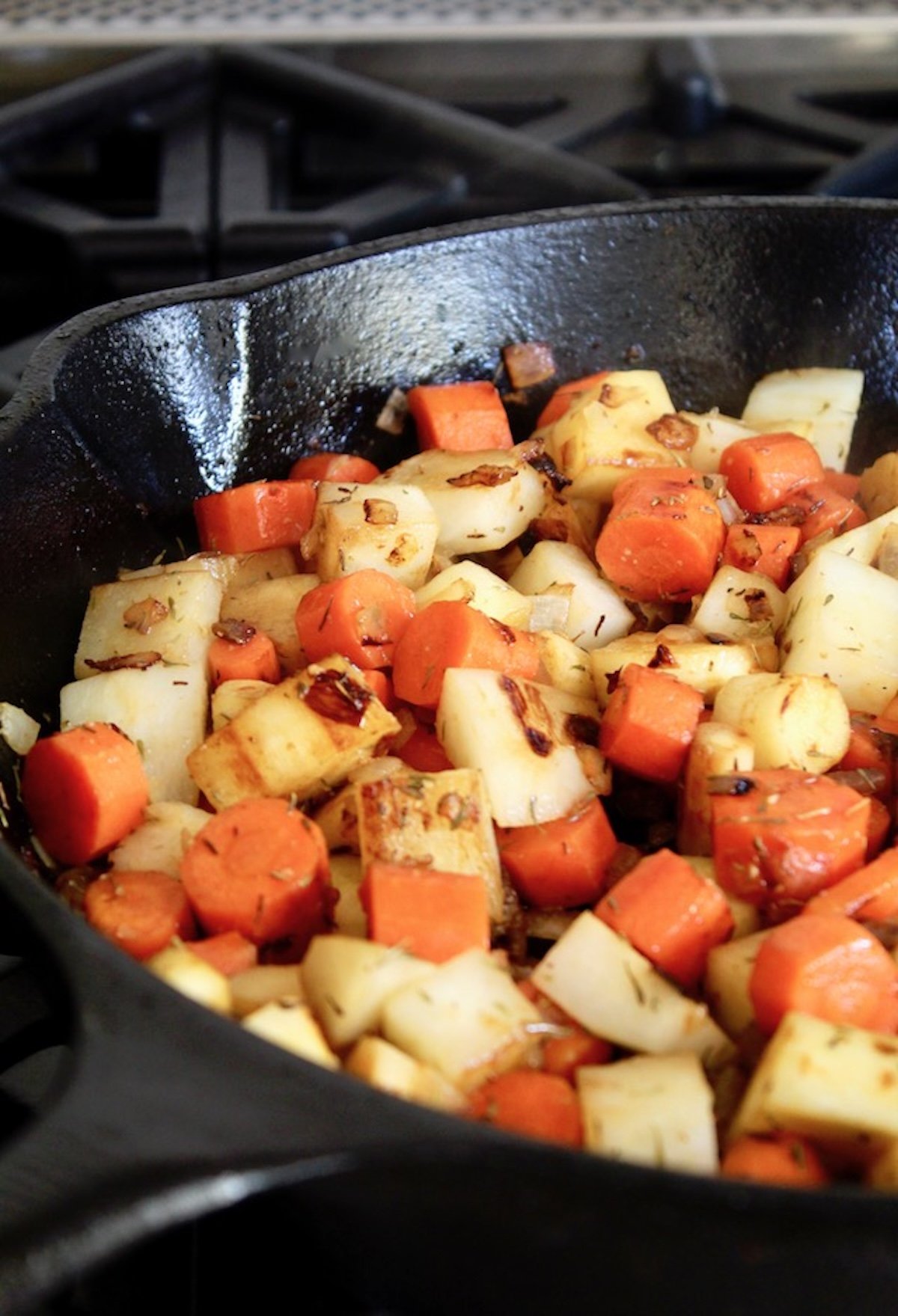 Root-Vegetable-Lasagna-with-Carrots Browned root vegetables in a cast iron skillet.